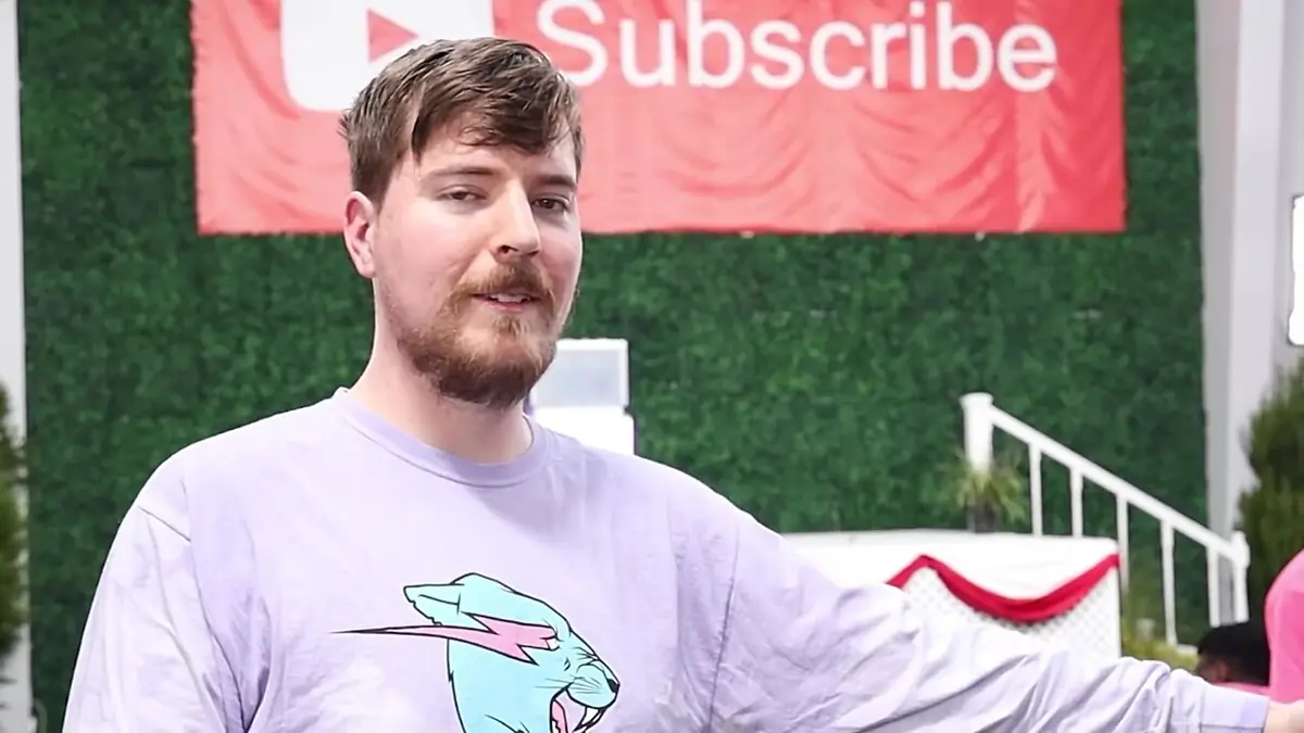MrBeast in a lilac shirt in front of a YouTube Subscribe banner