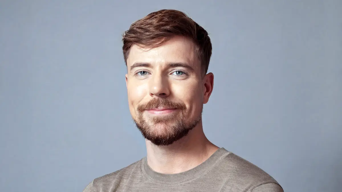 Jimmy Donaldson, MrBeast, smiling, arms folded, against a grey backdrop